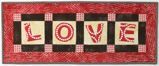 "Love" is a Free Valentine's Day Quilted Table Runner Pattern designed by Christa from Christa Quilts!
